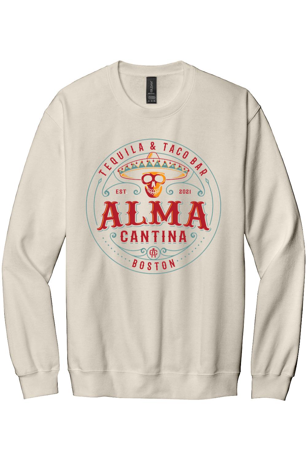 Beige crewneck sweatshirt featuring an Alma Cantina Boston tequila and taco bar logo with a colorful skull graphic.
