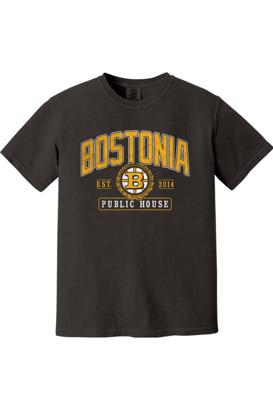 Black Comfort Colors t-shirt featuring a gold and white Bostonia Public House hockey-style logo graphic.