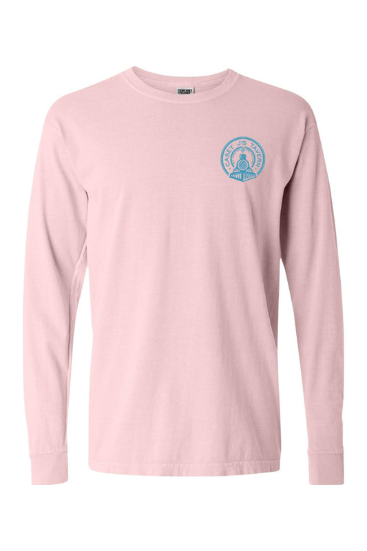 Light pink Comfort Colors long sleeve t-shirt featuring a small blue Casey J's Tavern train logo on the chest.