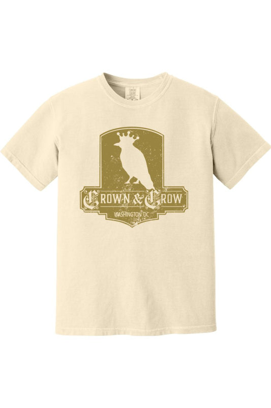 Cream-colored garment-dyed cotton t-shirt featuring a distressed gold Crown & Crow logo graphic on the chest.