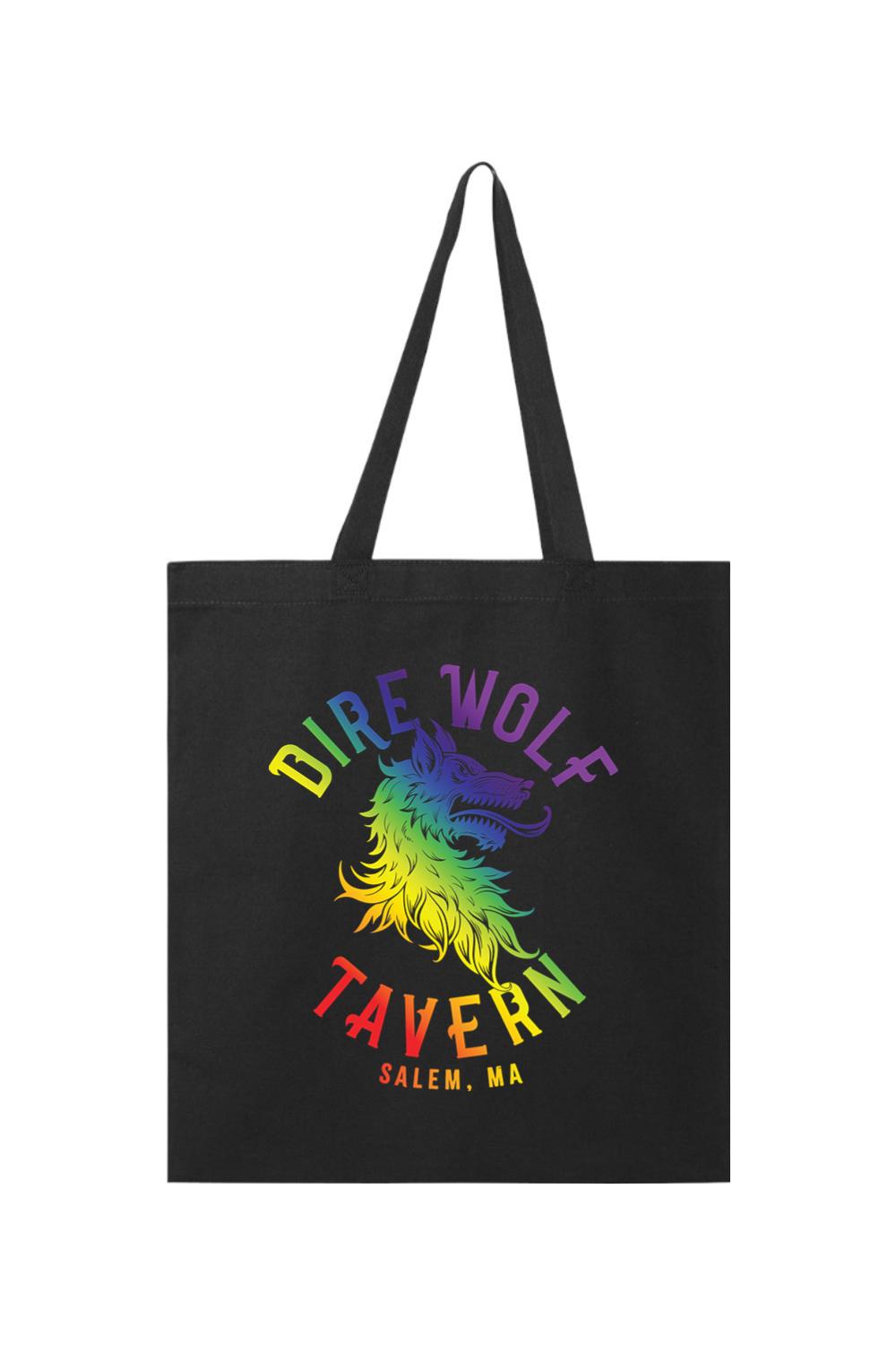 Black canvas tote bag featuring a rainbow-colored Dire Wolf Tavern logo with Salem, MA text.