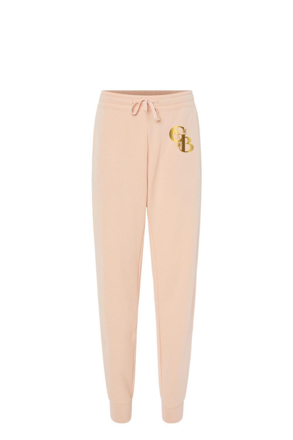 Light peach Golden Banana women's fleece sweatpants with a drawstring waist and metallic gold GB logo on the hip.