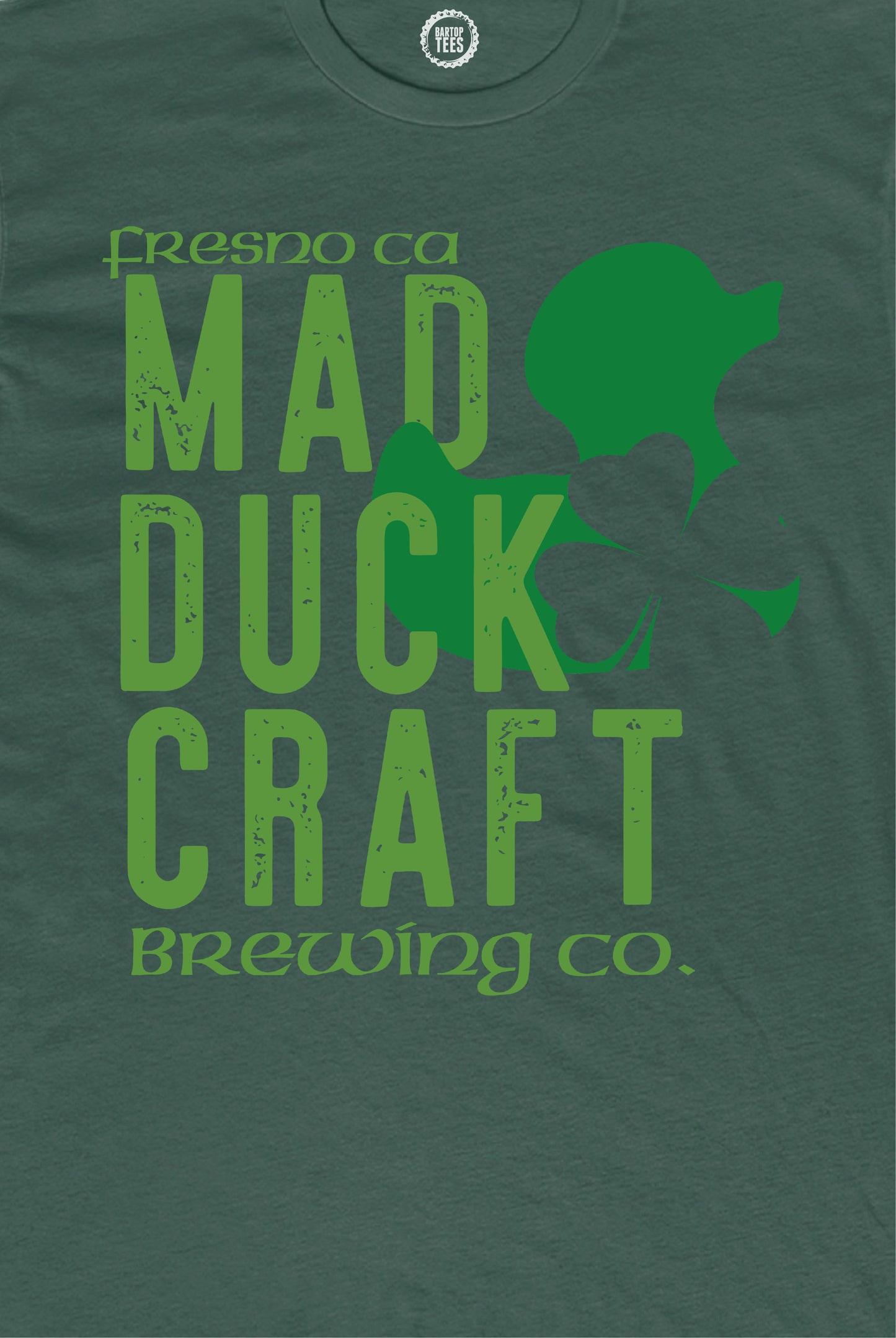 Forest green cotton t-shirt featuring a distressed Mad Duck Craft Brewing Co. logo and shamrock graphic.