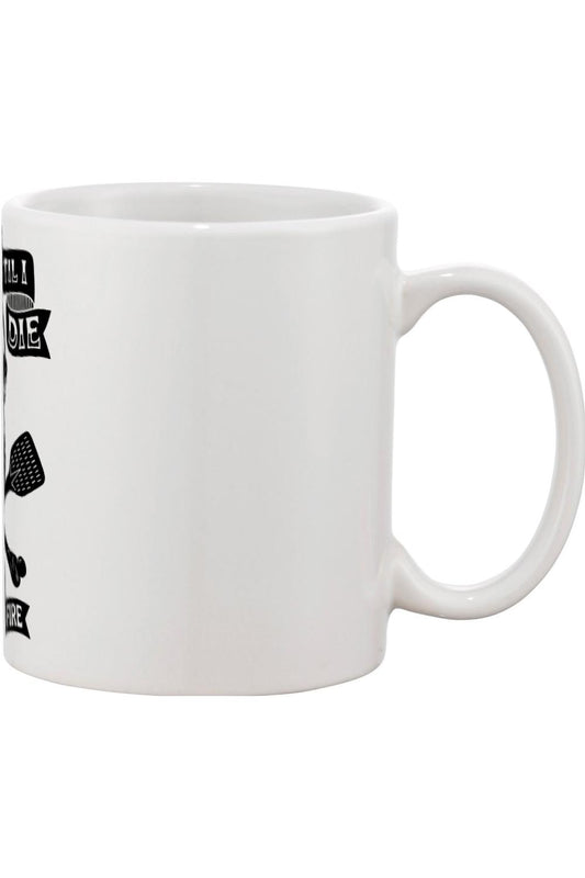 White 11oz ceramic mug featuring a black Pizza 'Til I Die graphic with pizza slice and cutter icons.