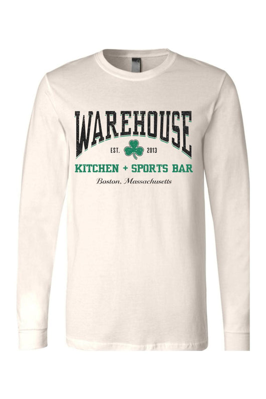Cream-colored long sleeve cotton t-shirt with Warehouse Kitchen + Sports Bar Boston logo and green clover graphic.