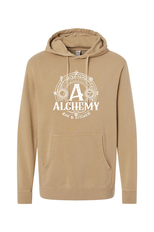 Tan pigment-dyed hoodie featuring a white Alchemy Bar & Kitchen circular graphic with sun and moon symbols.