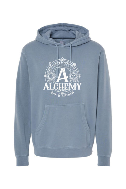 Blue pigment-dyed hoodie featuring a white Alchemy Bar & Kitchen circular graphic with a front kangaroo pocket.