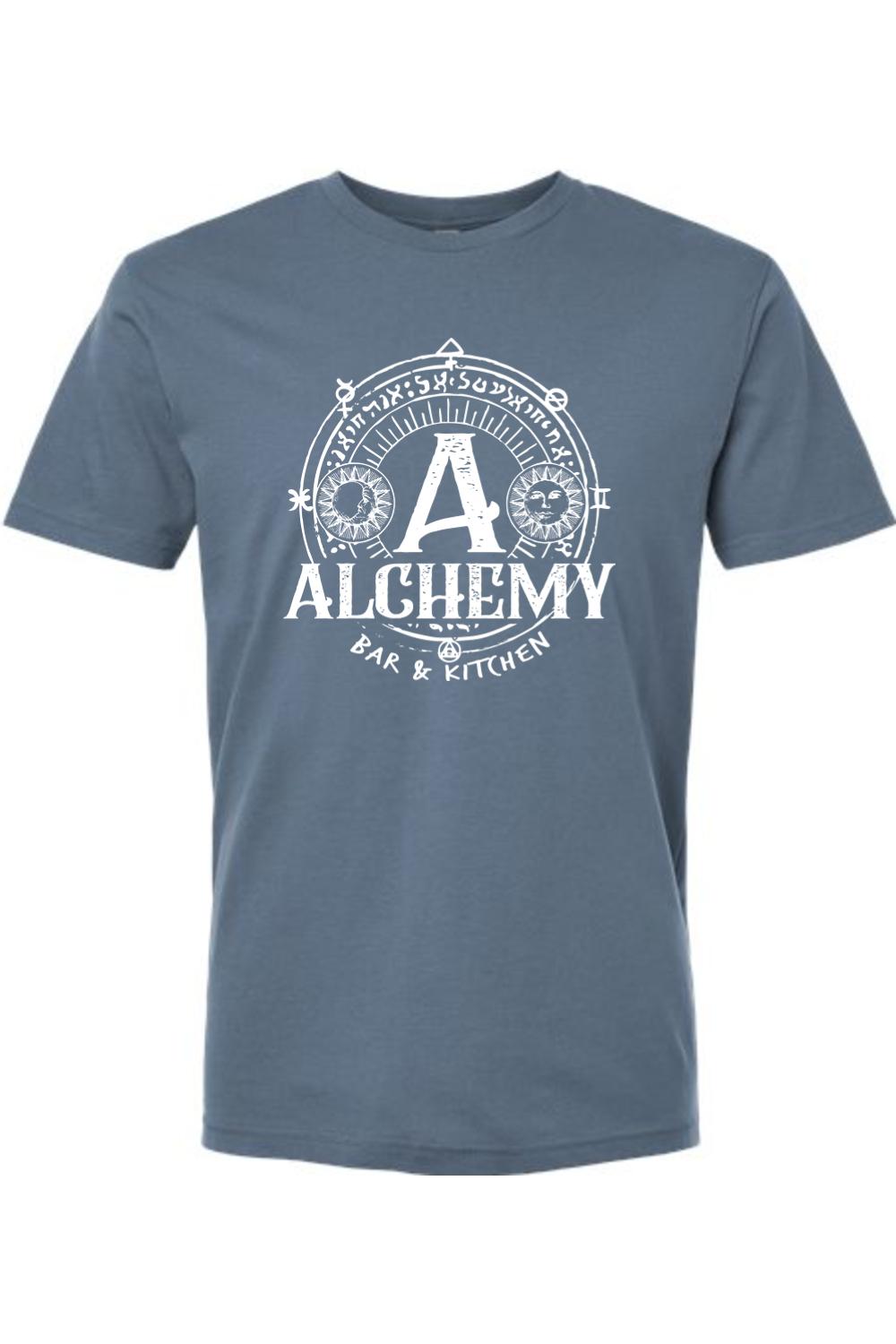 Blue crew neck t-shirt featuring a white Alchemy Bar & Kitchen circular graphic with sun and moon celestial symbols.