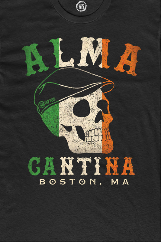 Black 100% cotton t-shirt featuring a distressed Irish flag skull graphic with Alma Cantina Boston text.