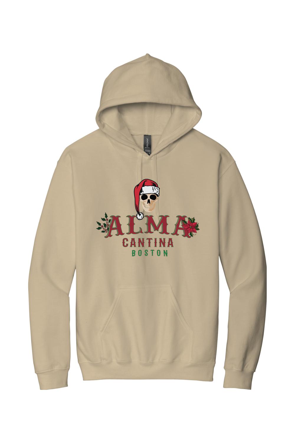 Tan cotton hoodie featuring a Santa-hat-wearing skull graphic and Alma Cantina Boston holiday branding.