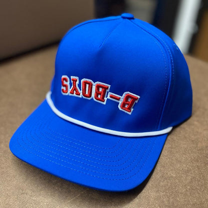 Royal blue baseball cap featuring a white rope trim and red embroidered B-BOYS text in a reversed design.