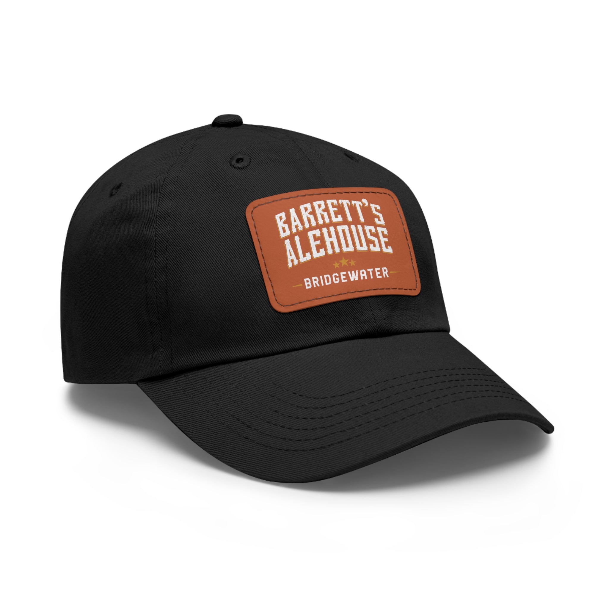 Black bio-washed chino twill dad cap featuring a brown faux leather patch with Barrett's Alehouse Bridgewater branding.