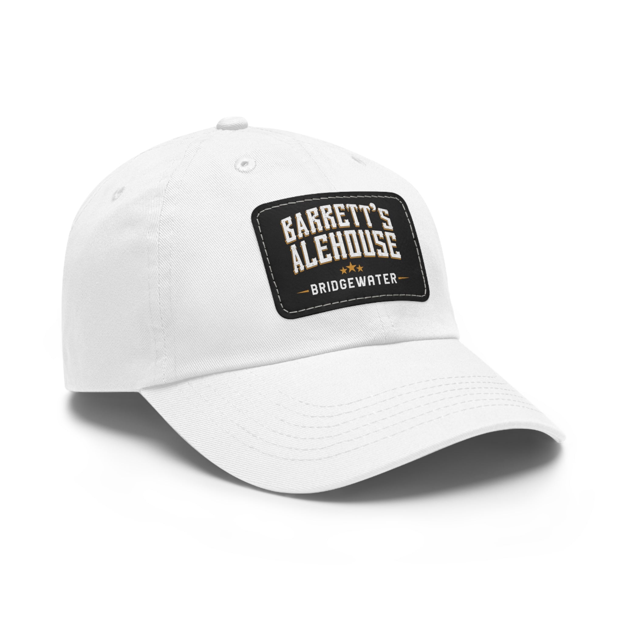 White bio-washed chino twill dad cap featuring a black faux leather patch with Barrett's Alehouse Bridgewater branding.