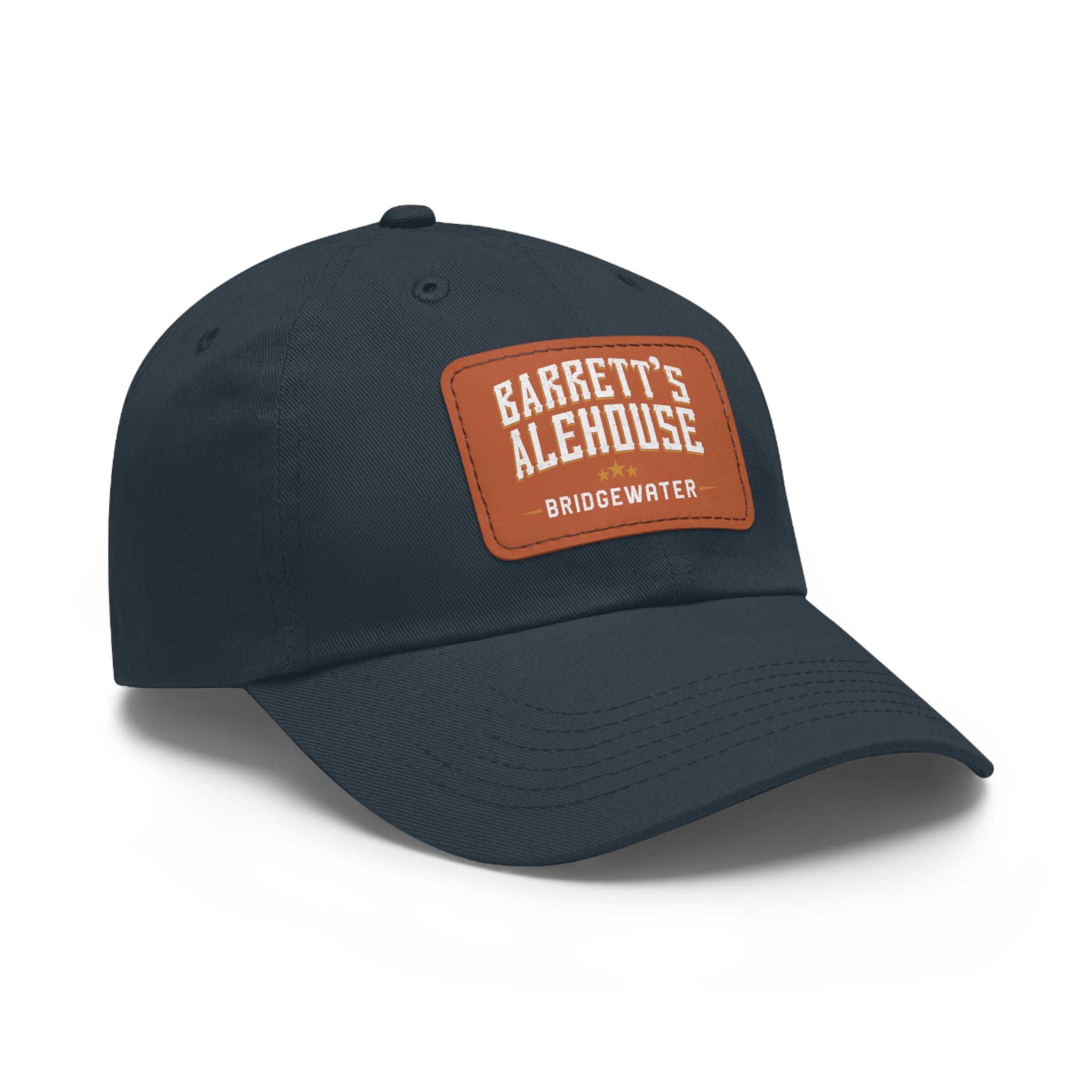 Navy blue bio-washed chino twill dad cap featuring a brown faux leather patch with Barrett's Alehouse Bridgewater branding.