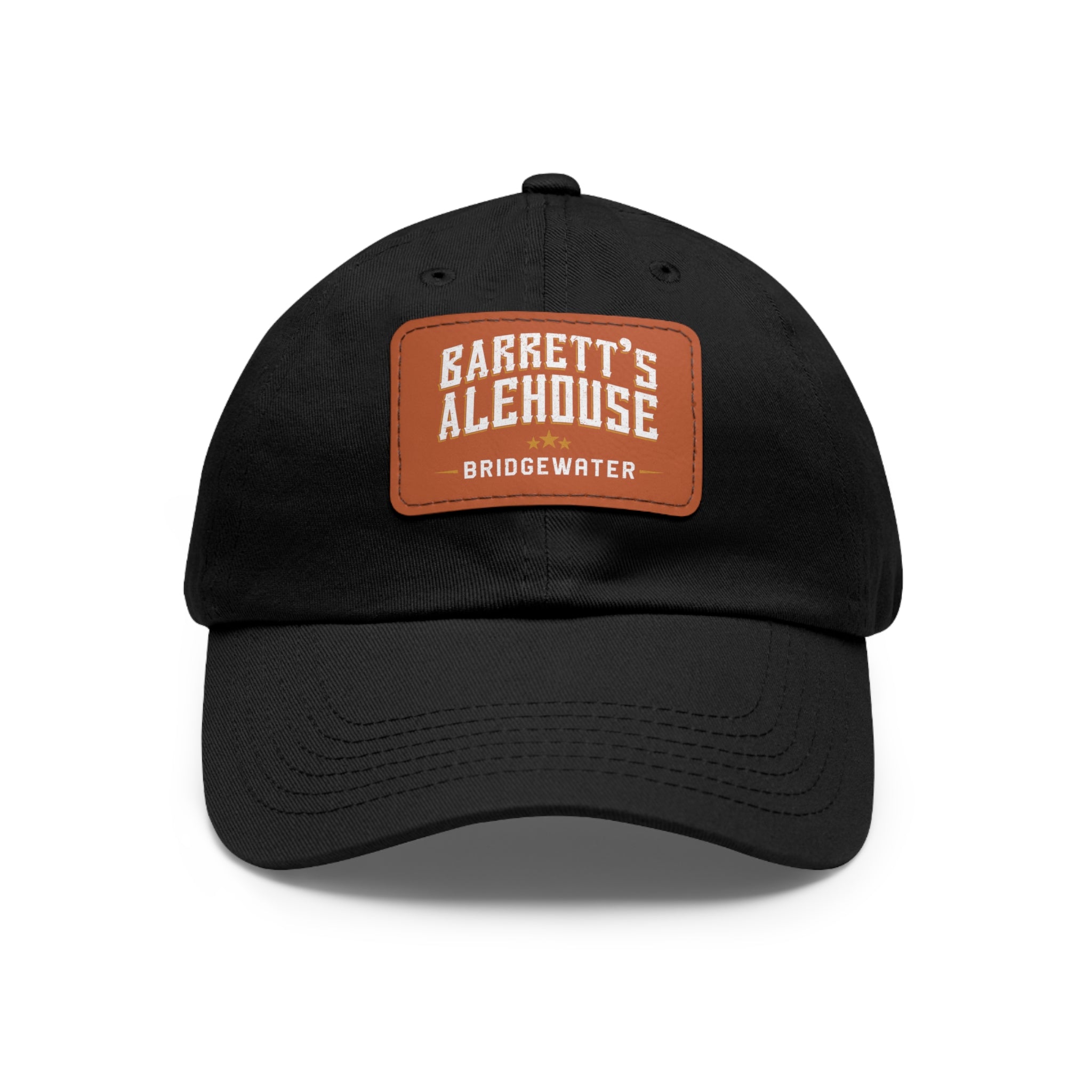 Black bio-washed chino twill dad cap featuring a brown faux leather patch with the Barrett's Alehouse Bridgewater logo.
