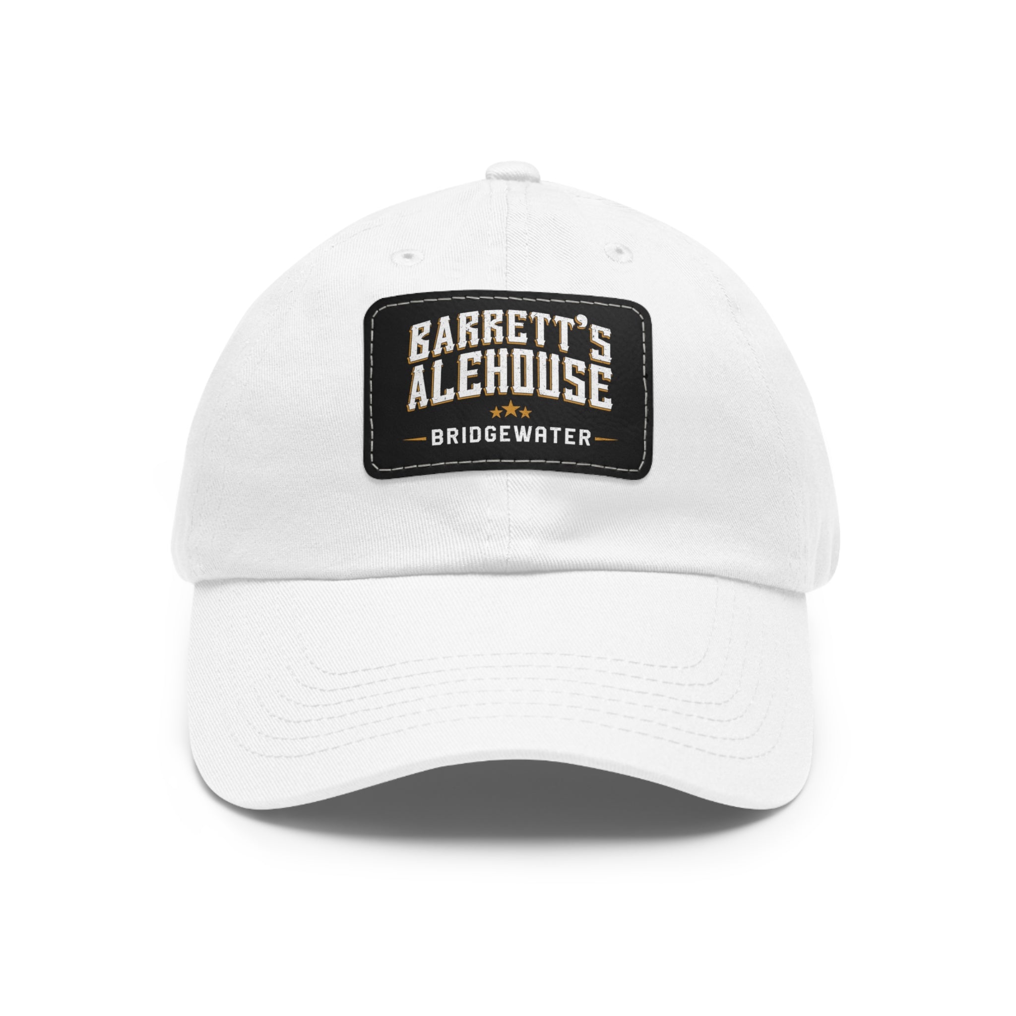 White bio-washed chino twill dad cap featuring a black faux leather patch with Barrett's Alehouse Bridgewater logo.