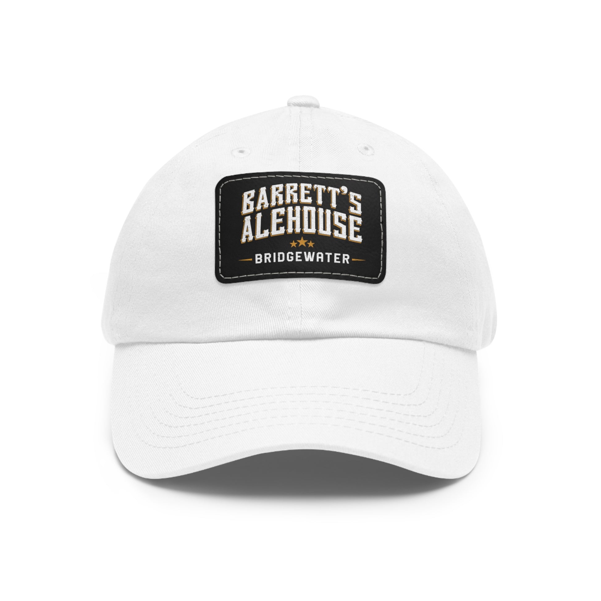 White bio-washed chino twill dad cap featuring a black faux leather patch with Barrett's Alehouse Bridgewater logo.