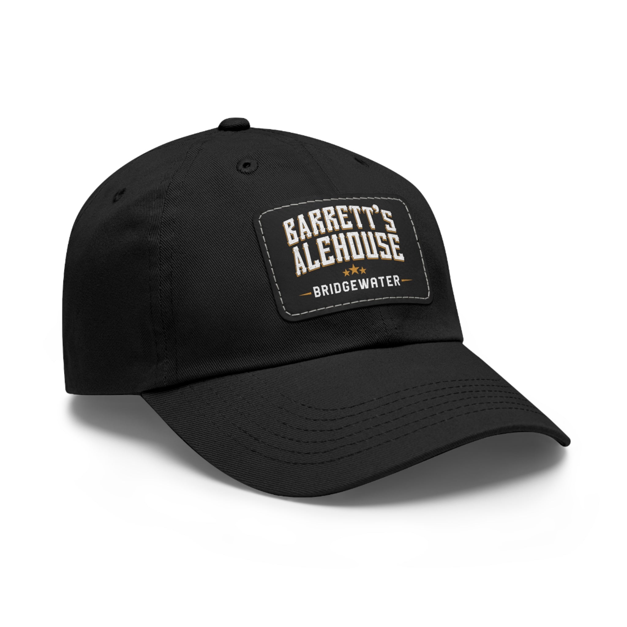 Black bio-washed chino twill dad cap with a stitched faux leather patch featuring the Barrett's Alehouse logo.