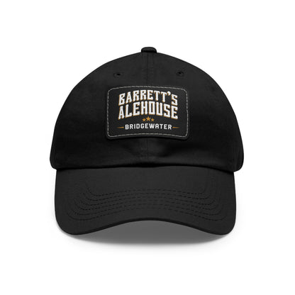 Black bio-washed chino twill dad cap featuring a rectangular faux leather patch with Barrett's Alehouse Bridgewater logo.
