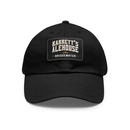 Black bio-washed chino twill dad cap featuring a rectangular faux leather patch with Barrett's Alehouse Bridgewater logo.