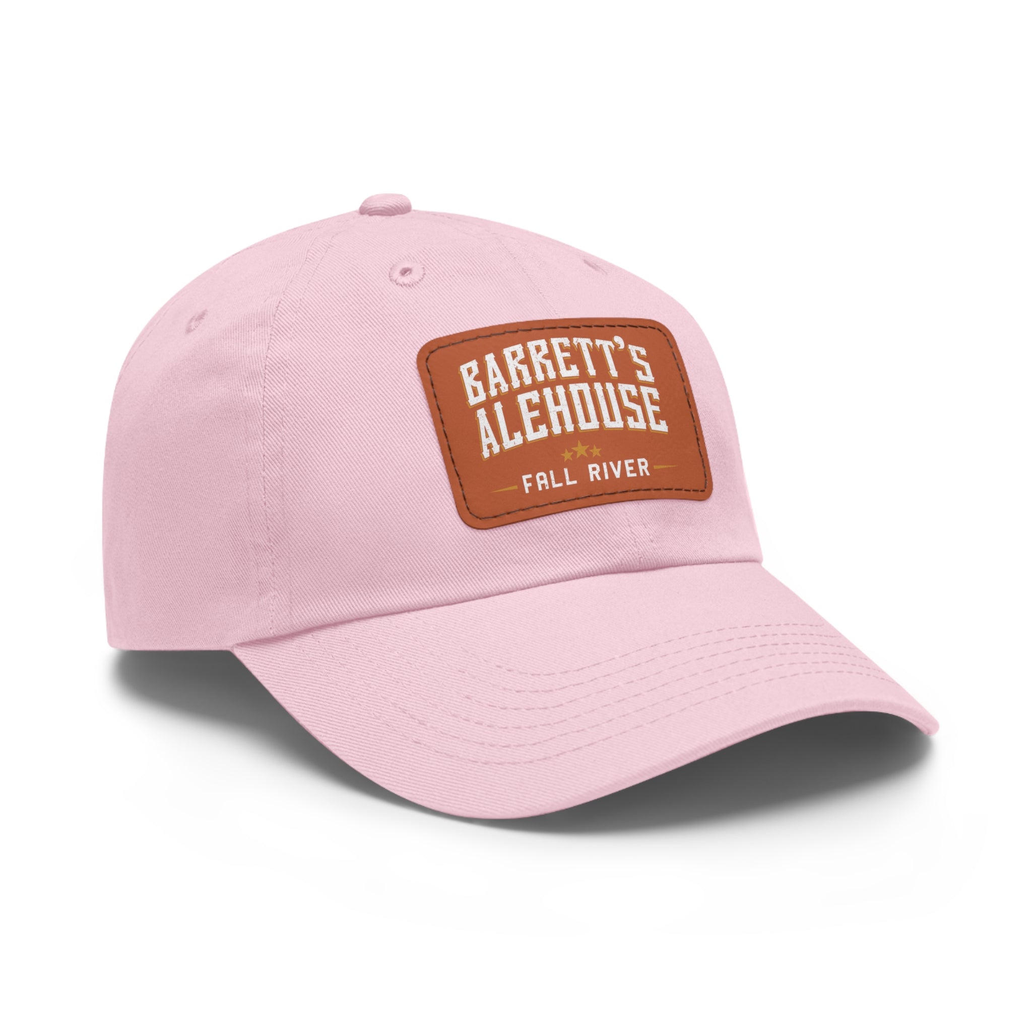 Light pink unstructured dad hat with a brown faux leather patch featuring the Barrett's Alehouse Fall River logo.