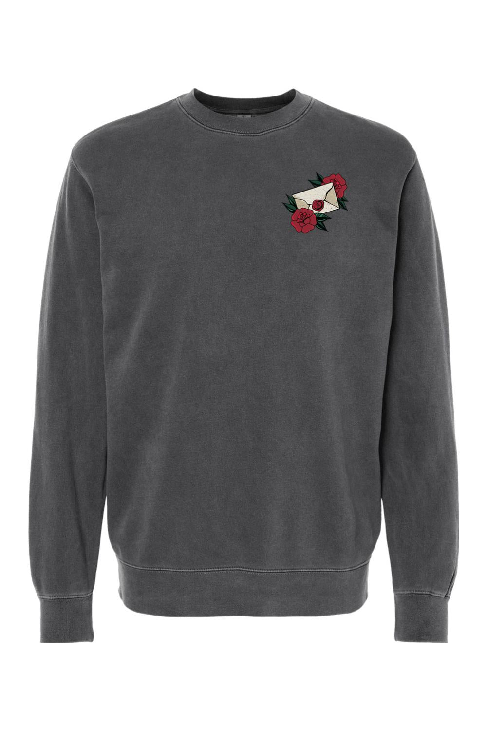 Charcoal pigment-dyed crewneck sweatshirt featuring a small envelope and red rose graphic on the left chest.