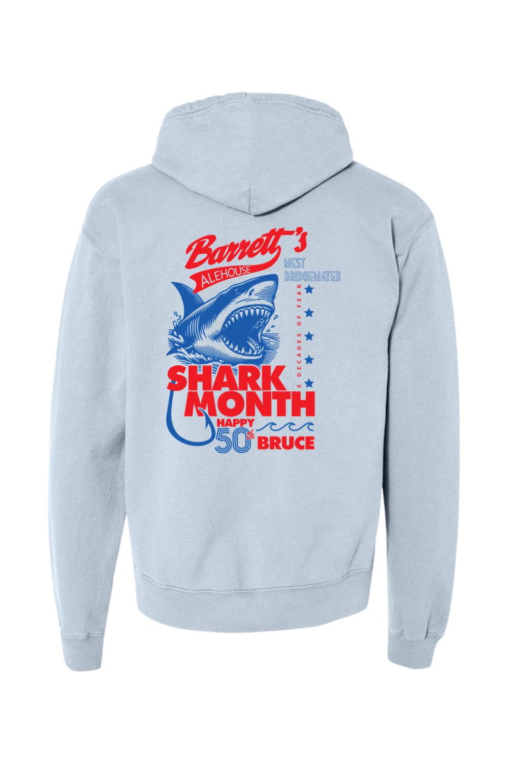 Light blue garment-dyed hoodie featuring a red and blue Barrett's Alehouse Shark Month 50th anniversary back graphic.