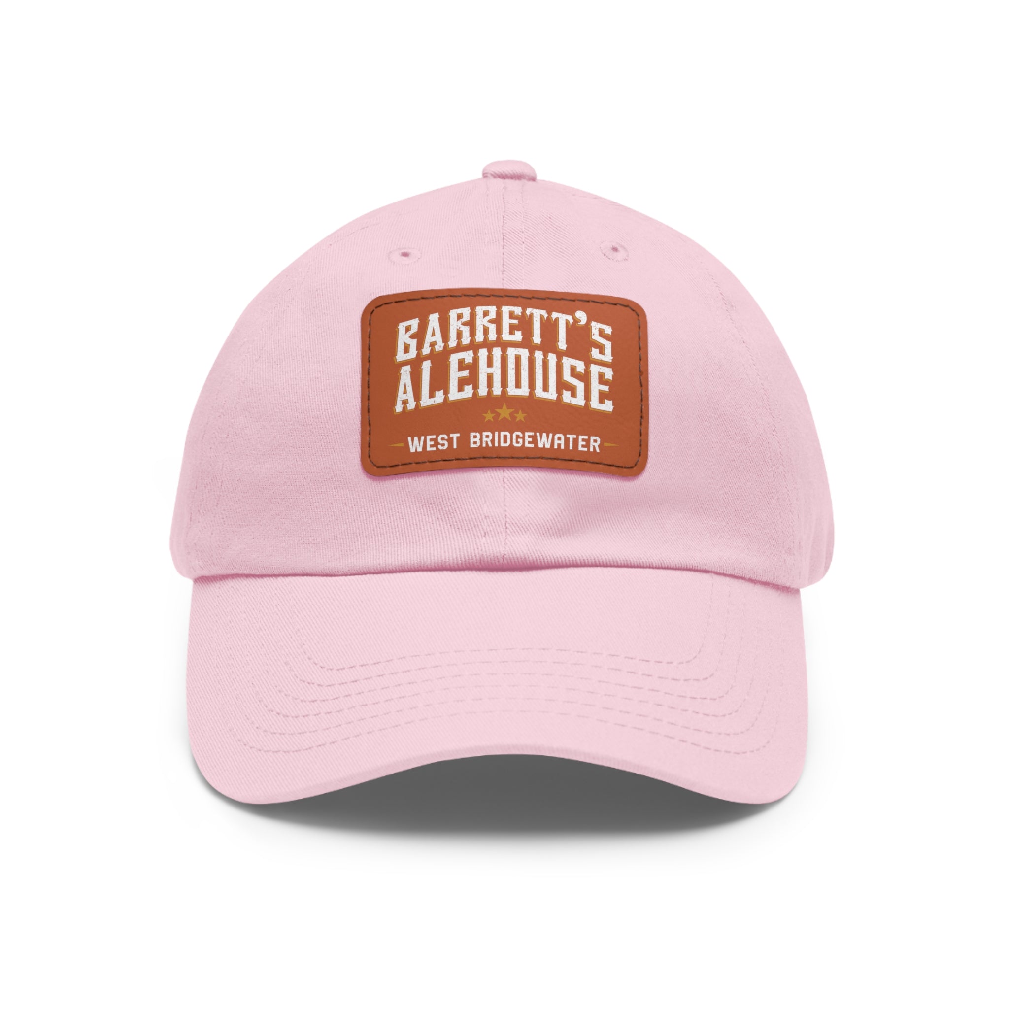 Light pink unstructured dad hat with a brown faux leather patch featuring the Barrett's Alehouse logo.
