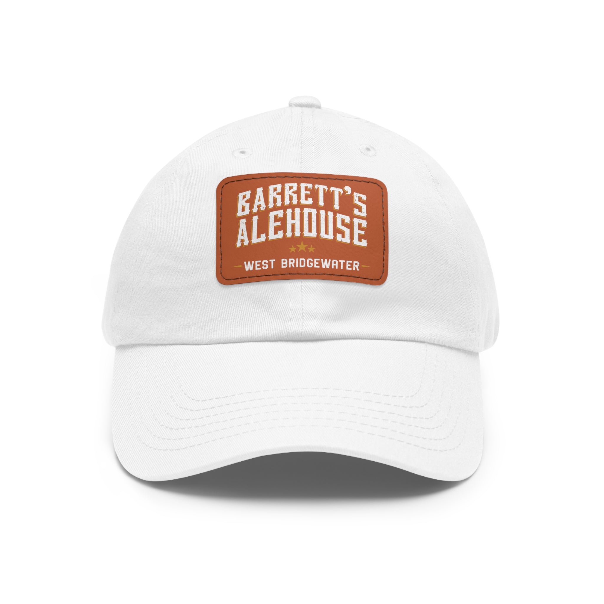 White unstructured dad hat with a brown faux leather patch featuring the Barrett's Alehouse West Bridgewater logo.