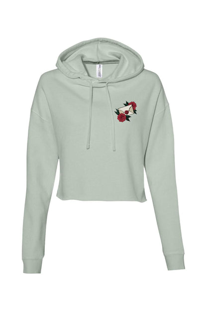 Sage green cropped hoodie with a small envelope and red rose graphic on the chest and a drawstring hood.