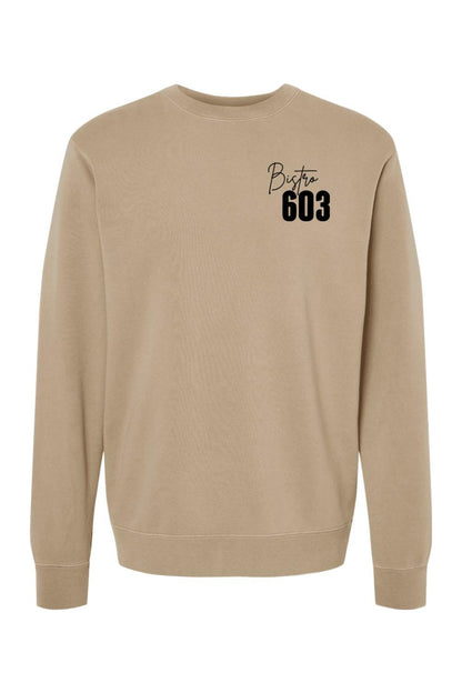 Tan pigment-dyed crewneck sweatshirt featuring a black Bistro 603 logo on the chest in a soft cotton-blend fabric.
