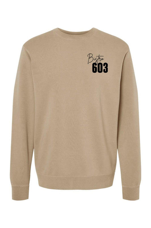 Tan pigment-dyed crewneck sweatshirt featuring a black Bistro 603 logo on the chest in a soft cotton-blend fabric.