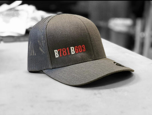 Structured grey six-panel hat with mesh back, featuring embroidered B781 B603 text and a curved visor.