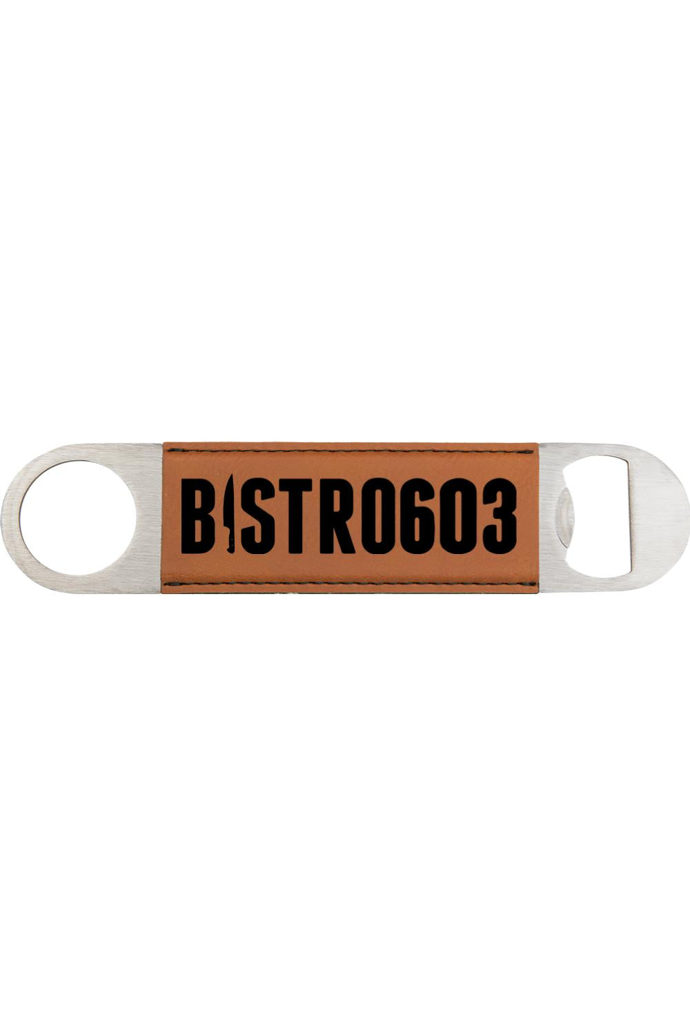 Tan leatherette bottle opener with a stainless steel frame and engraved Bistro603 logo in black.