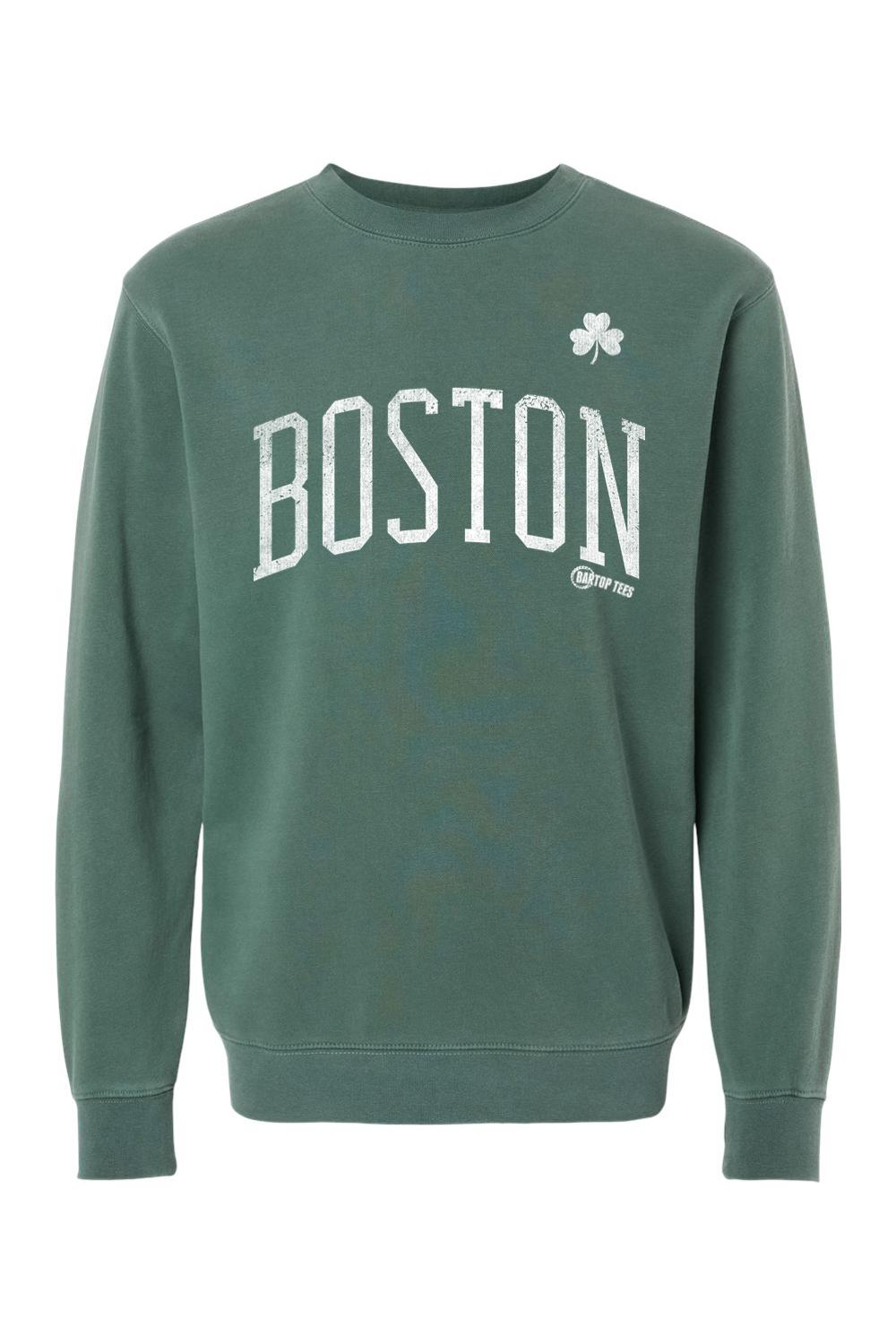 Pigment-dyed forest green crewneck sweatshirt featuring white distressed BOSTON text and a small clover graphic.