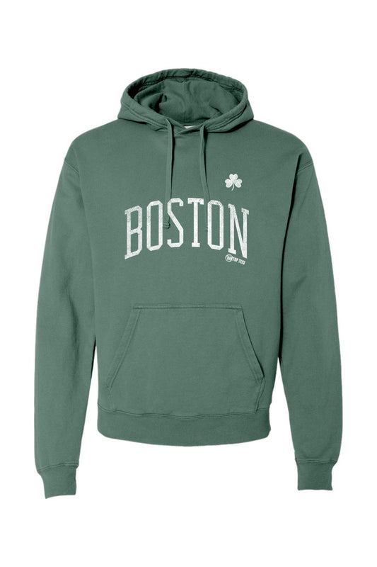 Men's pigment-dyed clover green hooded sweatshirt featuring white Boston text and a small shamrock graphic.