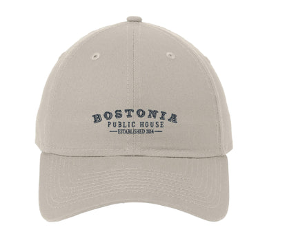 Beige unstructured cotton cap with a precurved visor and Bostonia Public House embroidery on the front.