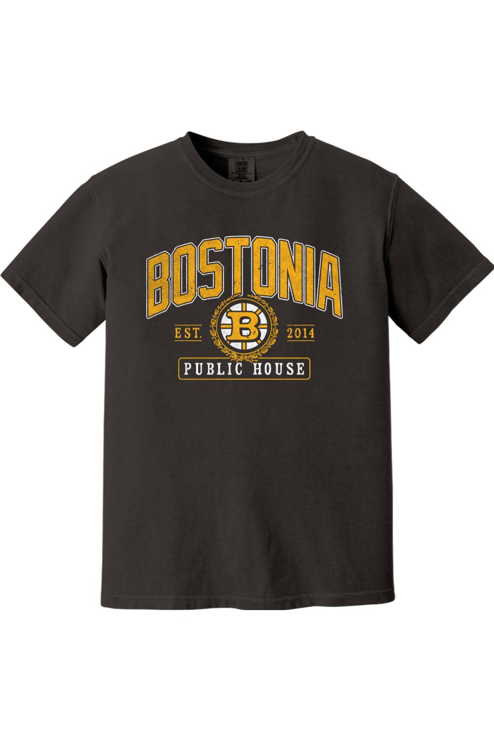 Black Comfort Colors t-shirt featuring a gold and white Bostonia Public House hockey-style logo graphic.