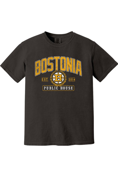 Black Comfort Colors t-shirt featuring a gold and white Bostonia Public House hockey-style logo graphic.