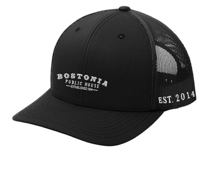 Black Bostonia Public House structured trucker cap with breathable mesh back and adjustable snap closure.