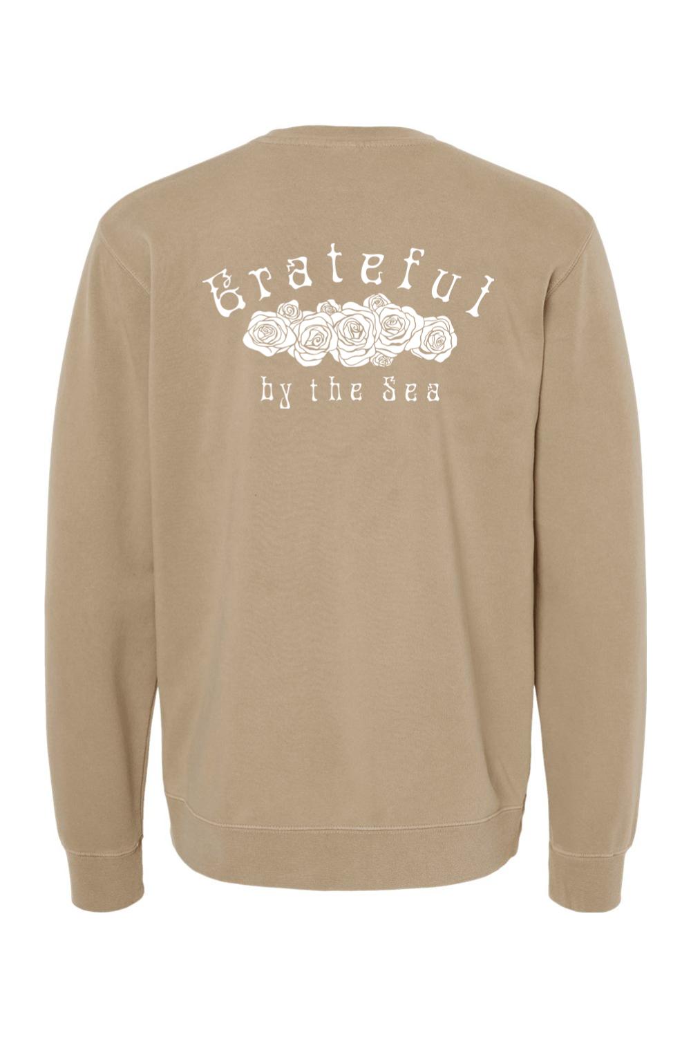 Tan pigment-dyed crewneck sweatshirt featuring a white Grateful by the Sea rose graphic on the back.