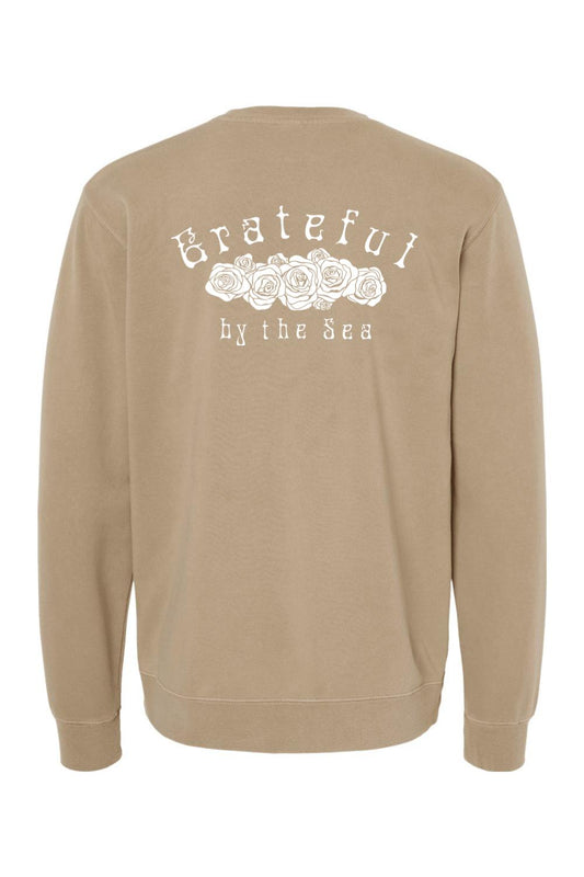 Tan pigment-dyed crewneck sweatshirt featuring a white Grateful by the Sea rose graphic on the back.