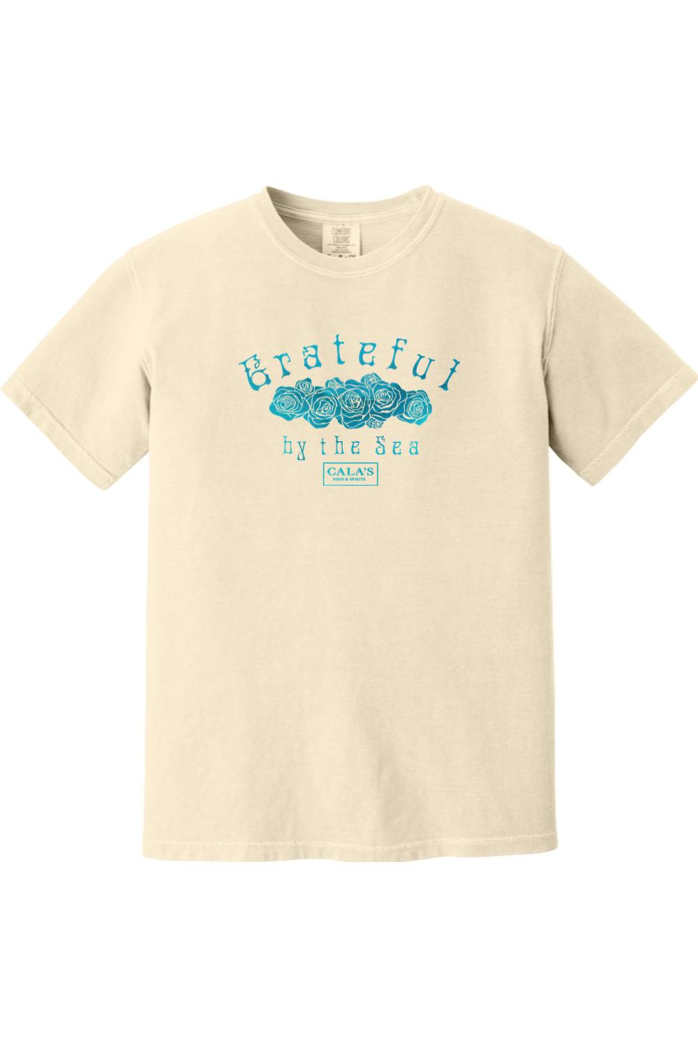 Cream-colored Comfort Colors t-shirt featuring a blue Grateful By The Sea rose graphic and Cala's Food & Spirits logo.