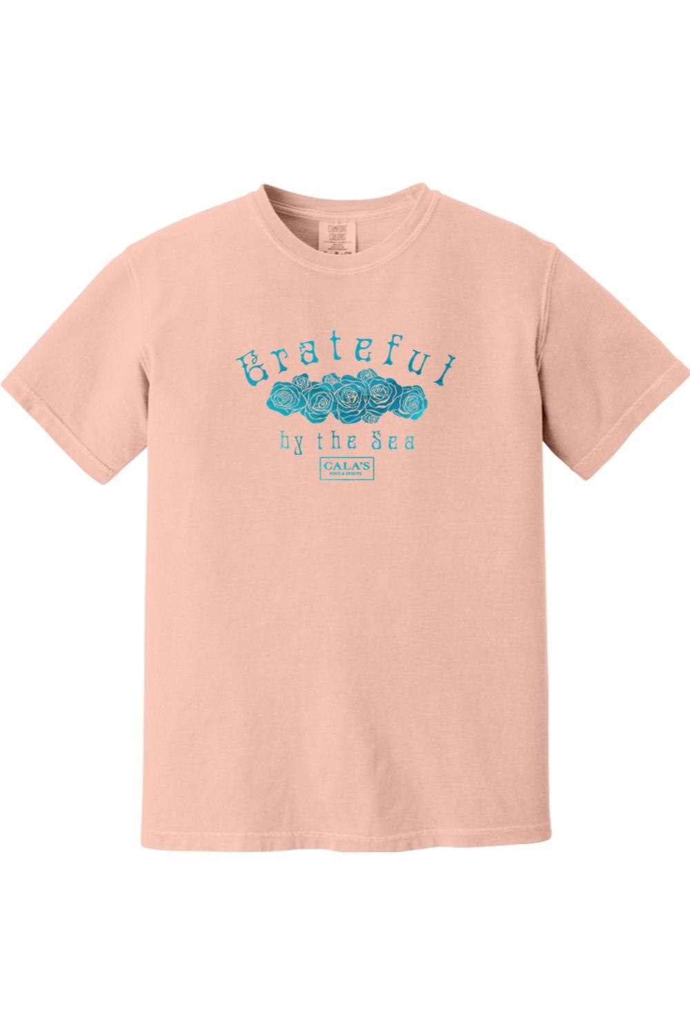 Soft peach Comfort Colors unisex t-shirt featuring a blue Grateful By The Sea rose graphic on the chest.
