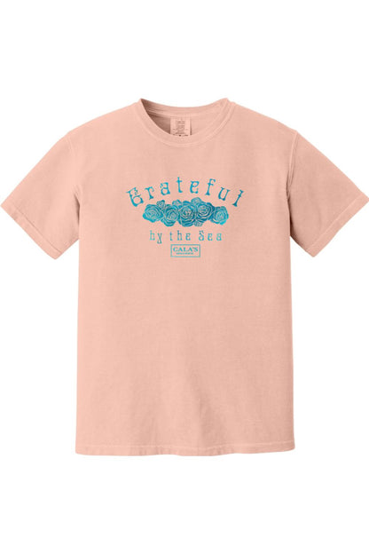 Soft peach Comfort Colors unisex t-shirt featuring a blue Grateful By The Sea rose graphic on the chest.