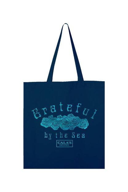 Navy blue canvas tote bag with a teal rose graphic and Grateful By The Sea text with Cala's Food & Spirits logo.