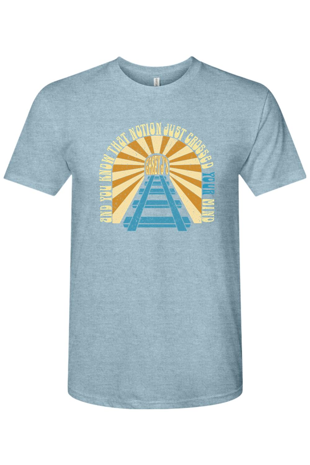 Light blue heathered triblend t-shirt featuring a vintage railroad graphic with yellow sunburst and Casey J's text.