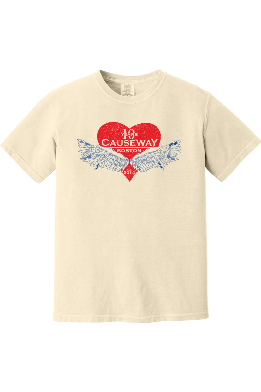 Cream-colored Comfort Colors short sleeve shirt featuring a red heart graphic with blue wings and Causeway 10th anniversary text.