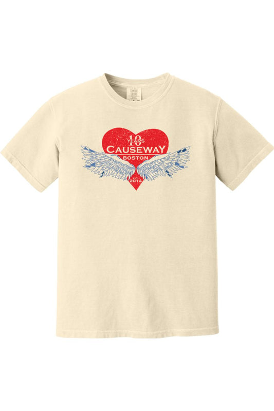 Cream-colored Comfort Colors short sleeve shirt featuring a red heart graphic with blue wings and Causeway 10th anniversary text.