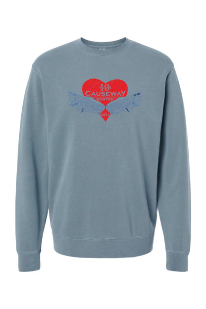 Blue pigment-dyed crewneck sweatshirt featuring a red heart graphic with wings and Causeway 10th anniversary text.